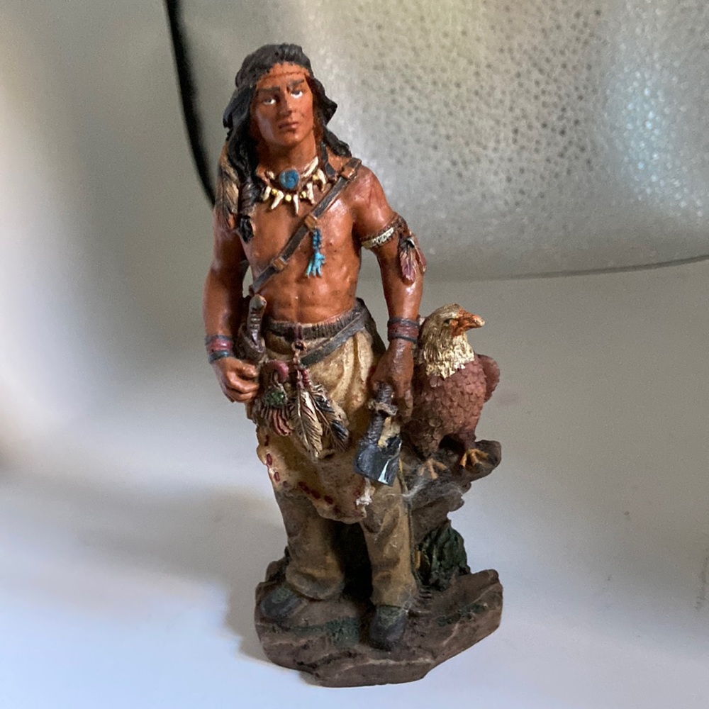 American Indian warrior standing with Eagle
